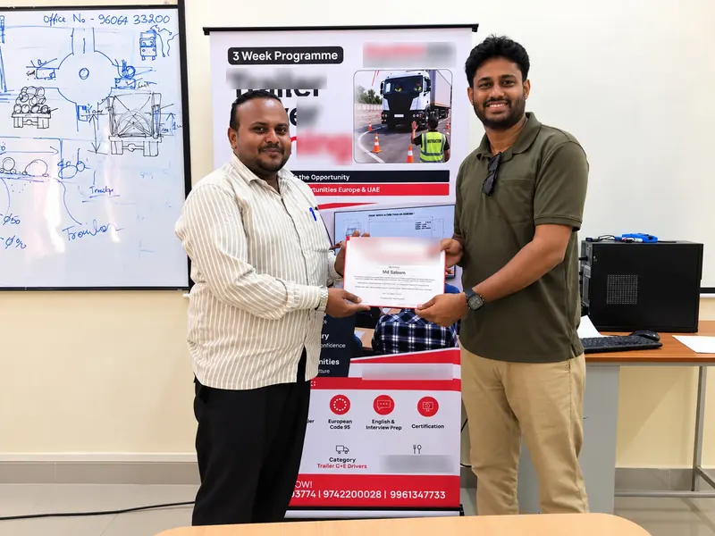 A candidate receiving his certificate of completion for the Trailer Driver Programme
